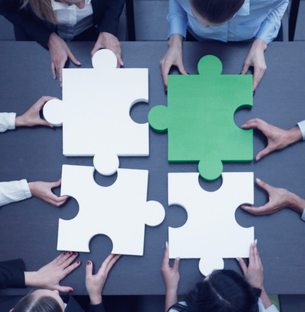 Business people assembling puzzle